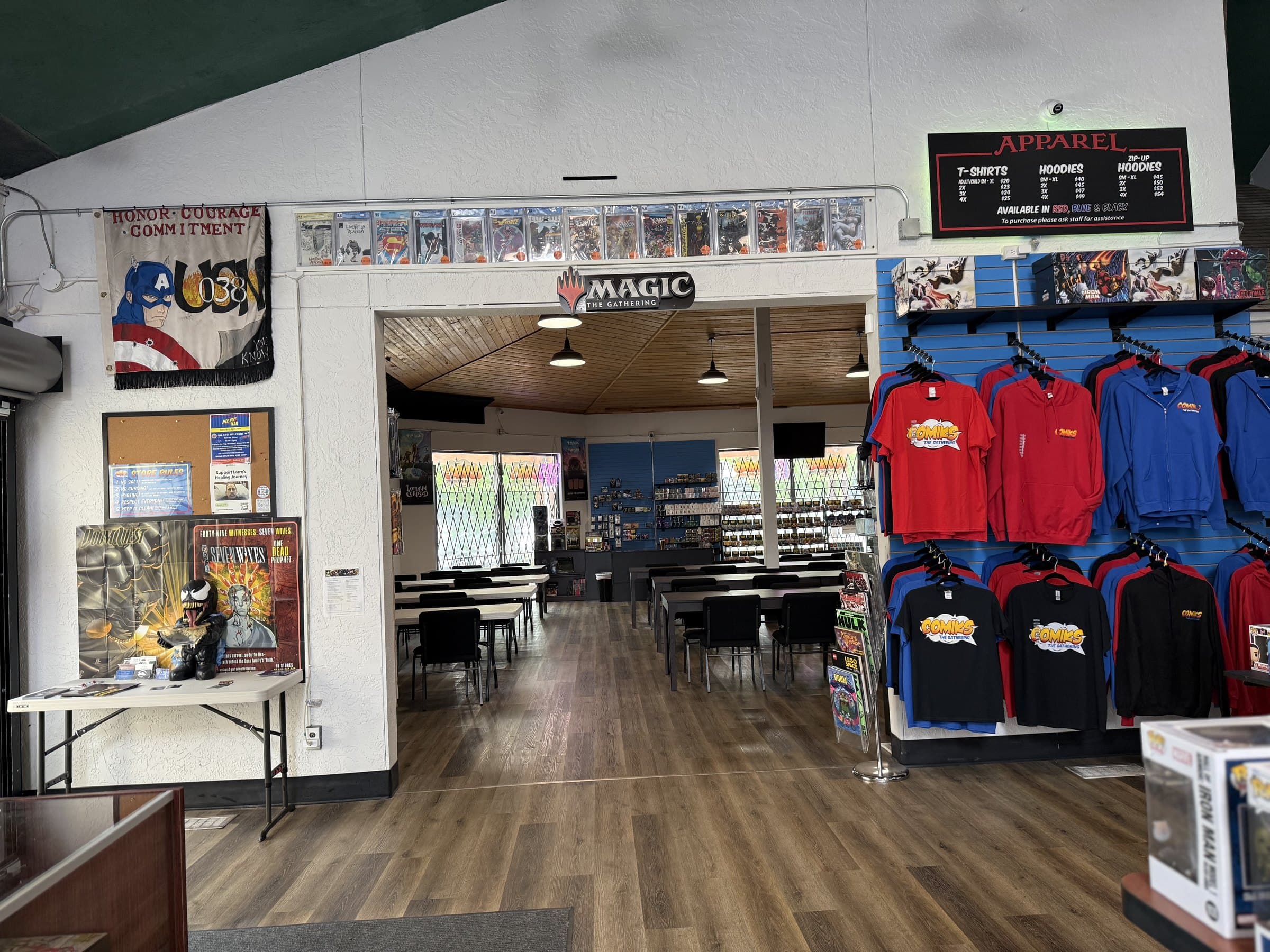 Entrance wall to the Magic: The Gathering game room at Comiks The Gathering showing the large play space beyond